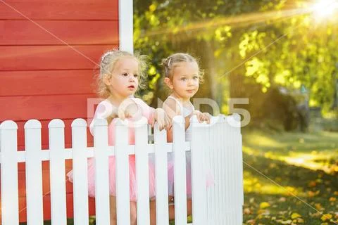 The two little girls at playground against park or green forest Stock Photos