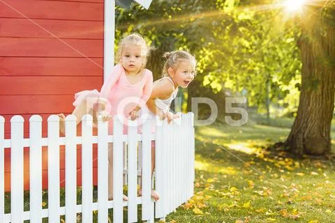 The two little girls at playground against park or green forest Stock Photos