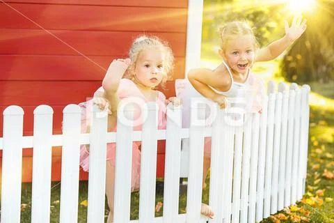 The two little girls at playground against park or green forest Stock Photos