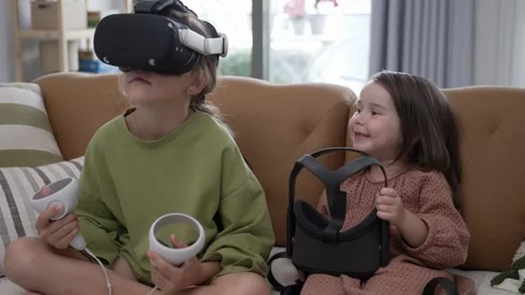 Two Little Girls Using a Virtual Reality Helmet Stock Footage 246126271