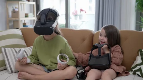 Two Little Girls Using a Virtual Reality Helmet Stock Footage 246632370