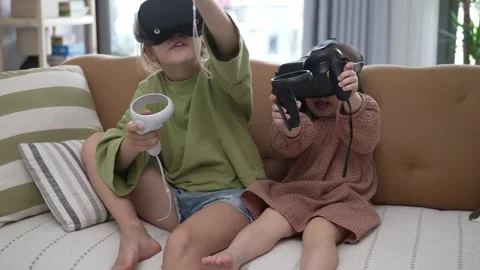 Two Little Girls Using a Virtual Reality Helmet Stock Footage 246738106