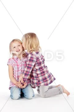 Two little girls whispering Stock Photos