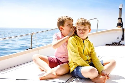 Two little kid boys, best friends enjoying sailing boat trip. Family vacations Stock Photos