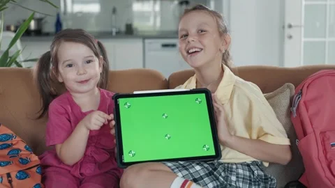 Two Little Sister are Using a Digital Tablet with Green Screen Stock Footage 248705829