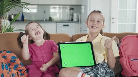 Two Little Sister are Using a Digital Tablet with Green Screen Stock Footage 248768184