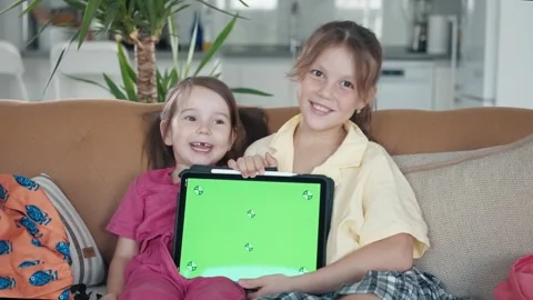 Two Little Sister are Using a Digital Tablet with Green Screen Stock Footage 248909081
