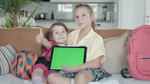 Two Little Sister are Using a Digital Tablet with Green Screen Stock Footage 249111437