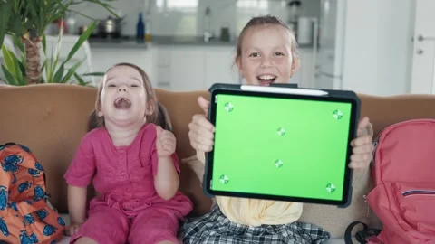 Two Little Sister are Using a Digital Tablet with Green Screen Stock Footage 249214126