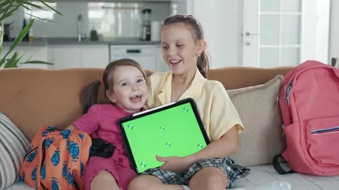 Two Little Sister are Using a Digital Tablet with Green Screen Stock Footage 249323101