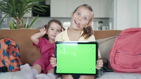 Two Little Sister are Using a Digital Tablet with Green Screen Stock Footage 249464702