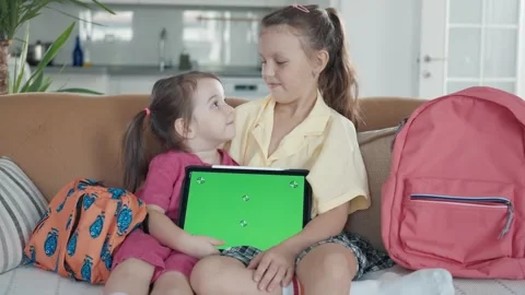 Two Little Sister are Using a Digital Tablet with Green Screen Stock Footage 249759587
