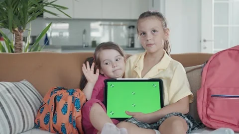 Two Little Sister are Using a Digital Tablet with Green Screen Video stock 250330883