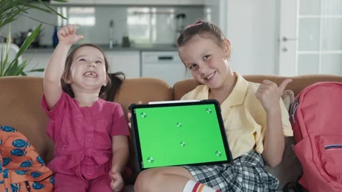Two Little Sister are Using a Digital Tablet with Green Screen Stock Footage 251135113