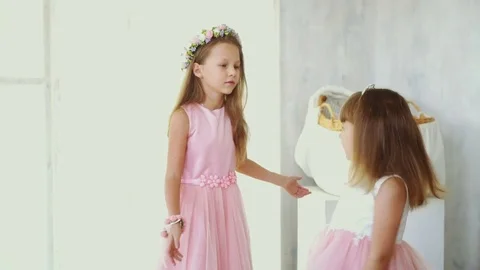 Two little sisters in beautiful dresses whirling Stock Footage 82475868