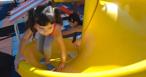 Two little  sisters have fun at the playground made in marine theme. 스톡 동영상 141642811