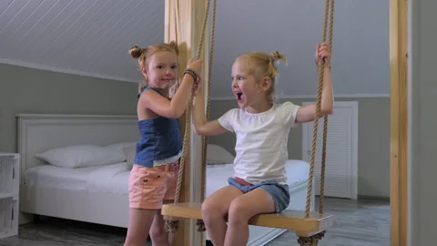 Two little sisters have fun at home while their parents are away. Stock Footage 145834149