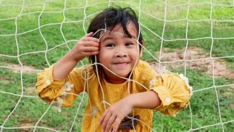 Two little sisters having fun to playing with rope net in summer park.  Stock Footage 160709060