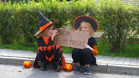 Two little sisters having fun together at Halloween holiday, trick or treat Stock Footage 179535876