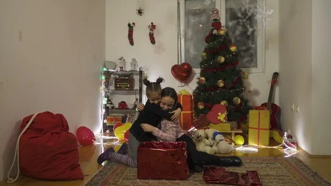 Two little sisters opening box with cute puppy, playful, new year and christmas. Stock Footage 99730279