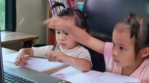 Two little sisters studying homework math during her online lesson at home. Stock Footage 160089950