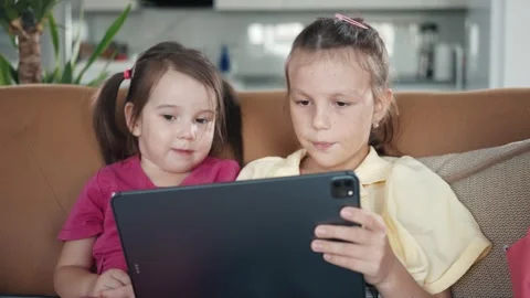 Two little sisters use digital tablet computer Stock Footage 255399448