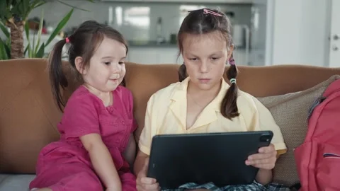 Two little sisters use digital tablet computer Stock Footage 255574642