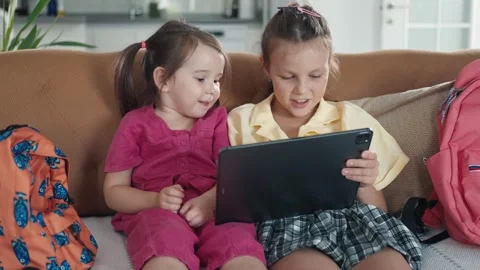 Two little sisters use digital tablet computer Stock Footage 257120866