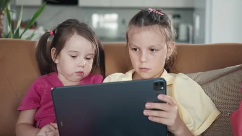 Two little sisters use digital tablet computer Stock Footage 259617273