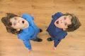 The two little twin brother with surprised emotion. View from above Photo