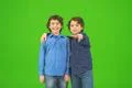 The two little twin gesture on the green background Photo