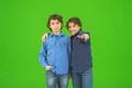 The two little twin gesture on the green background Photo