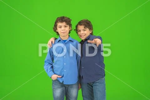 The two little twin gesture on the green background Stock Photos