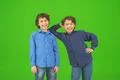 The two little twin stand on the green background Photo