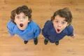 The two little twin with surprised emotion. View from above Photo