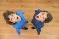 The two little twin with surprised emotion. View from above Photo