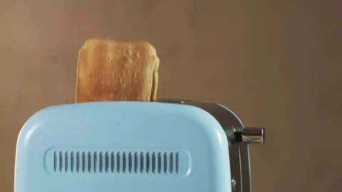 Two Loaves of Bread Jumping Out of an Electric Toaster Stock Footage 69174723