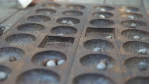 Two local men playing mancala game Stock Footage 85776145