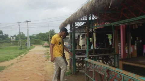 Two local young men are entering a tea stall Stock Footage 296526523
