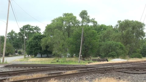 Two locomotive moving through a double-diamond and a crossing gate Stock Footage 99018384