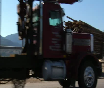 Two log trucks pass each other on the road Stock Footage 21594374