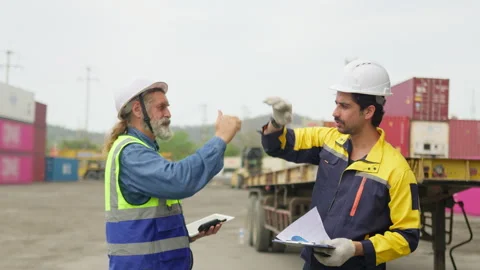 Two logistics workers give a high five to celebrate successful project Stock Footage 342280748