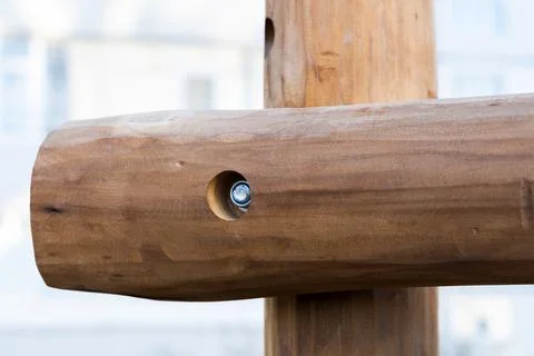 Two logs connected with a bolt. Close-up Stock Photos