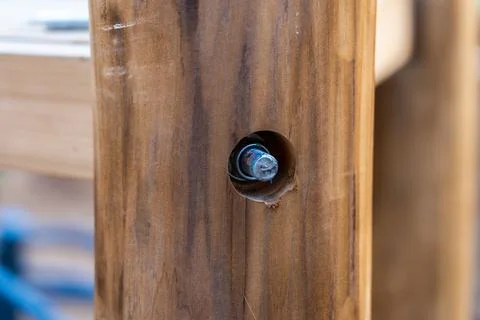 Two logs connected with a bolt. Selective focus Stock Photos