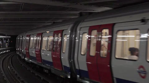 Two london underground tubes passing by Stock Footage 65494385