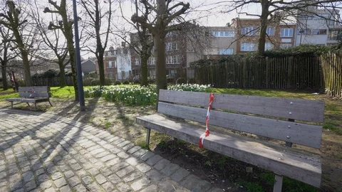 Two lonely forbidden benches wrapped with tape in good company of yellow Stock Footage 126804464