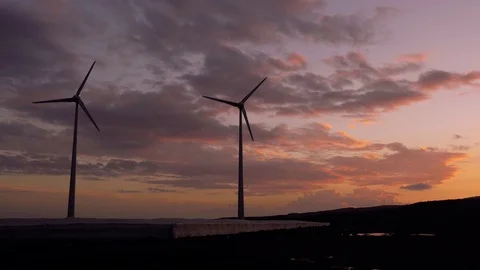 Two lonely wind generators working at sunset. Stock Footage 97464842