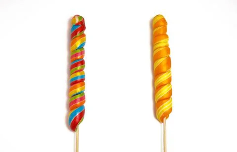 Two long multi-colored lollipops, isolated on a white background. Stock Photos