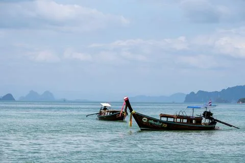 Two long tail boats floating on calm sea Krabi Photos
