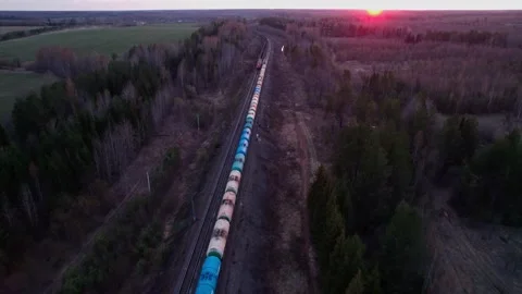 Two long trains ride under the rays of the sunset. Stock Footage 196519519